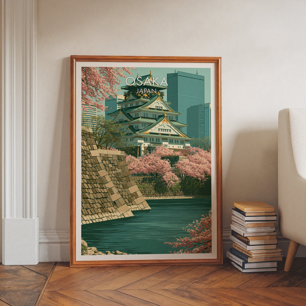 Osaka Castle Japan art print in a walnut frame leaning in a hallway beside stacked books
