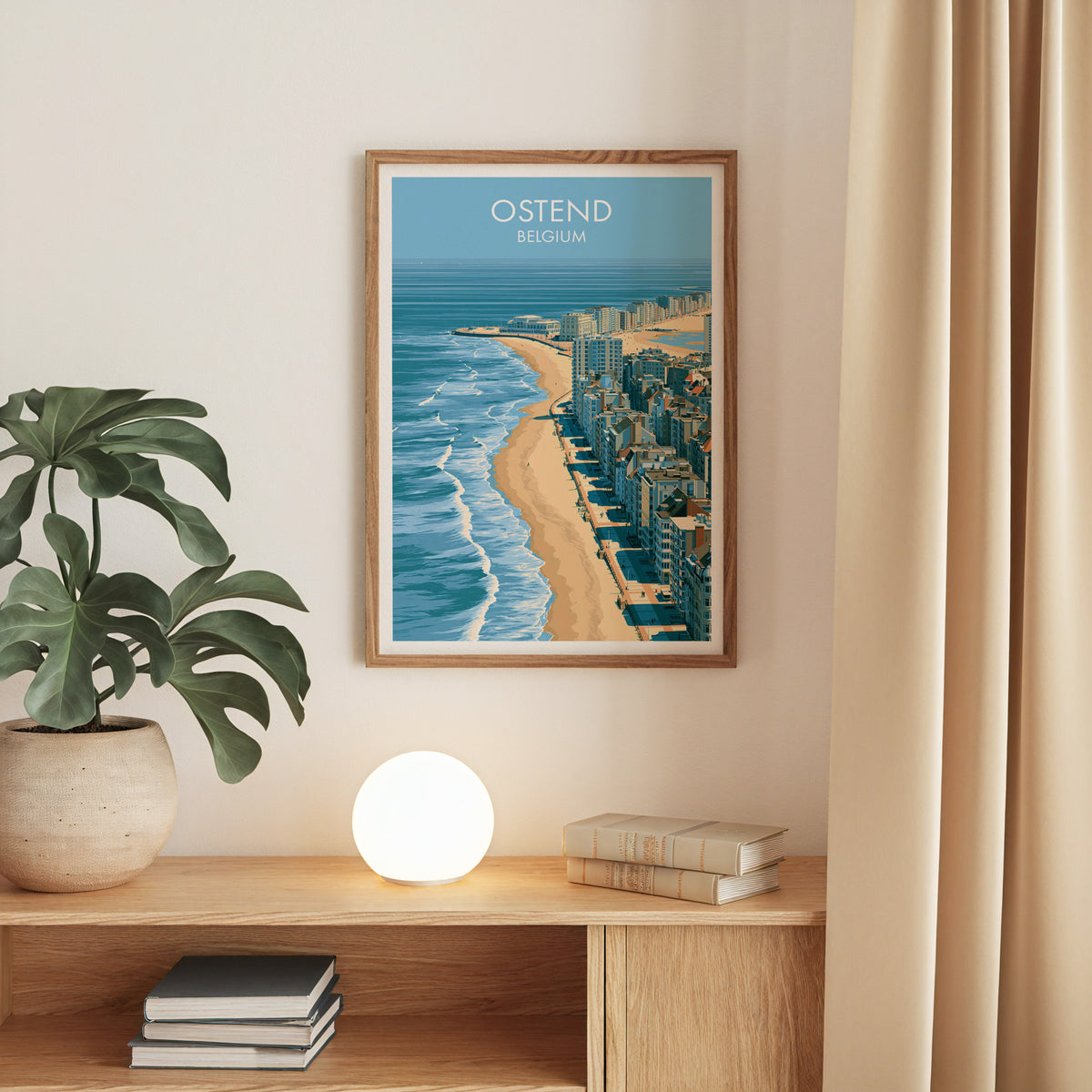 Ostend beach print, oak frame above an oak console with a monstera and a round globe lamp