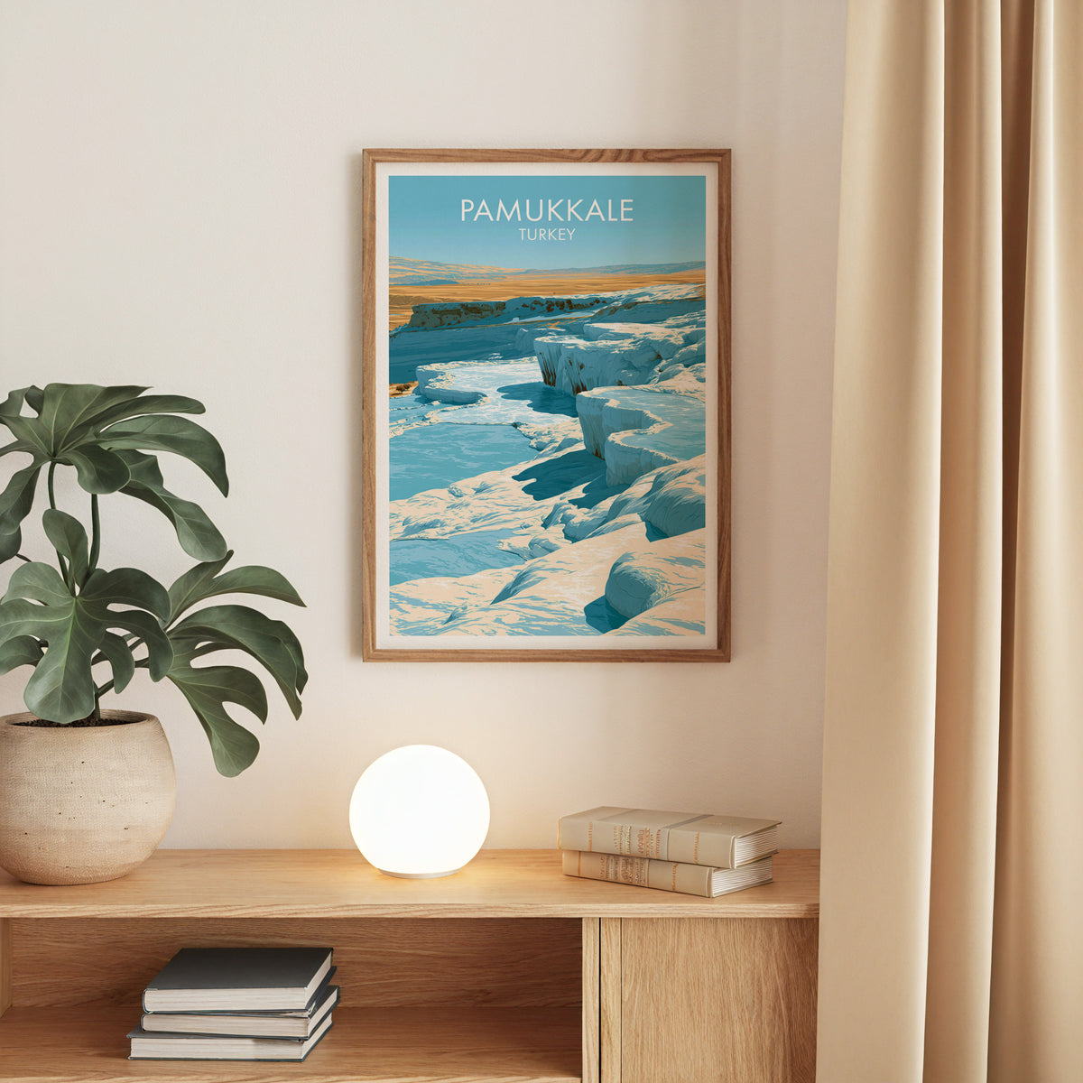Pamukkale travertine terraces print, oak frame above an oak console with a monstera and a round globe lamp