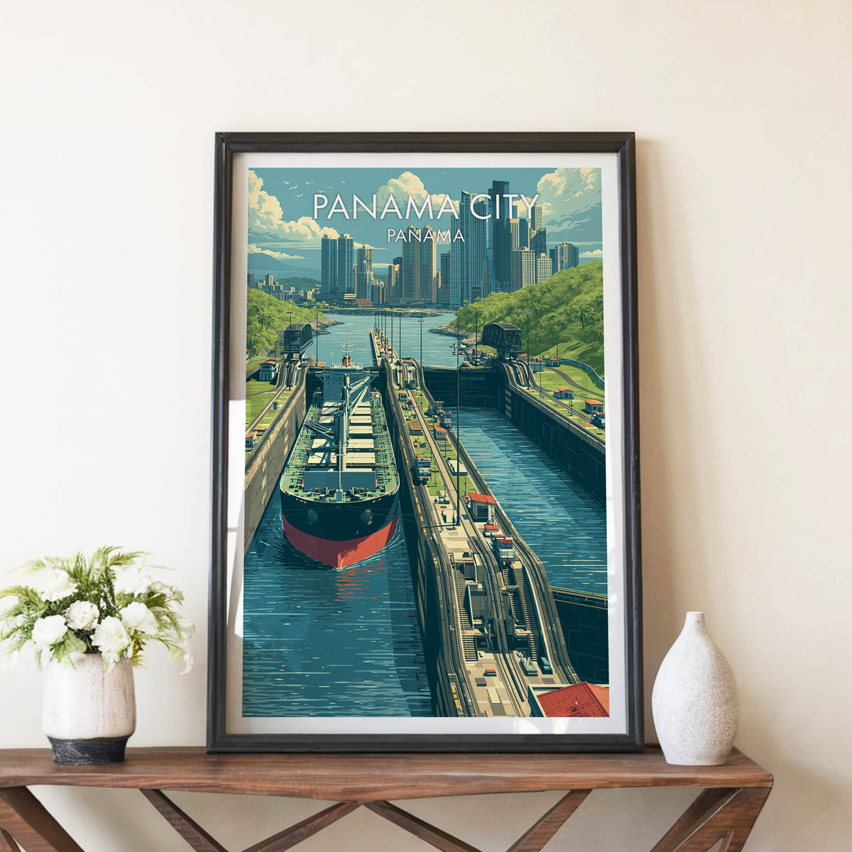 Canal locks poster in a black frame on a walnut console between white peonies and a pale ceramic vase
