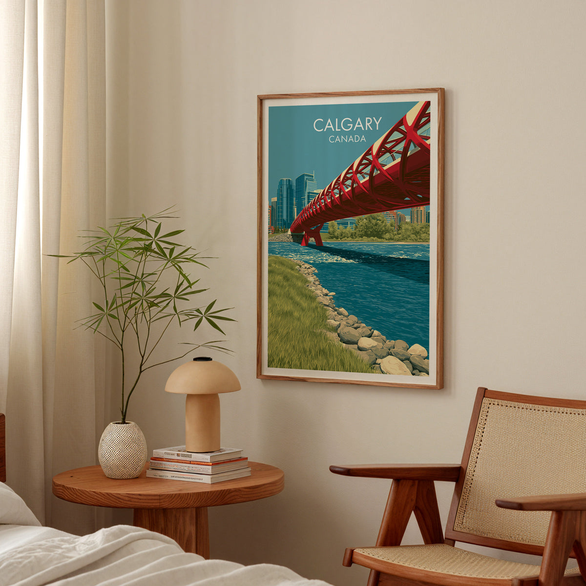 Peace Bridge Calgary poster in an oak frame above a bedside table with a mushroom lamp