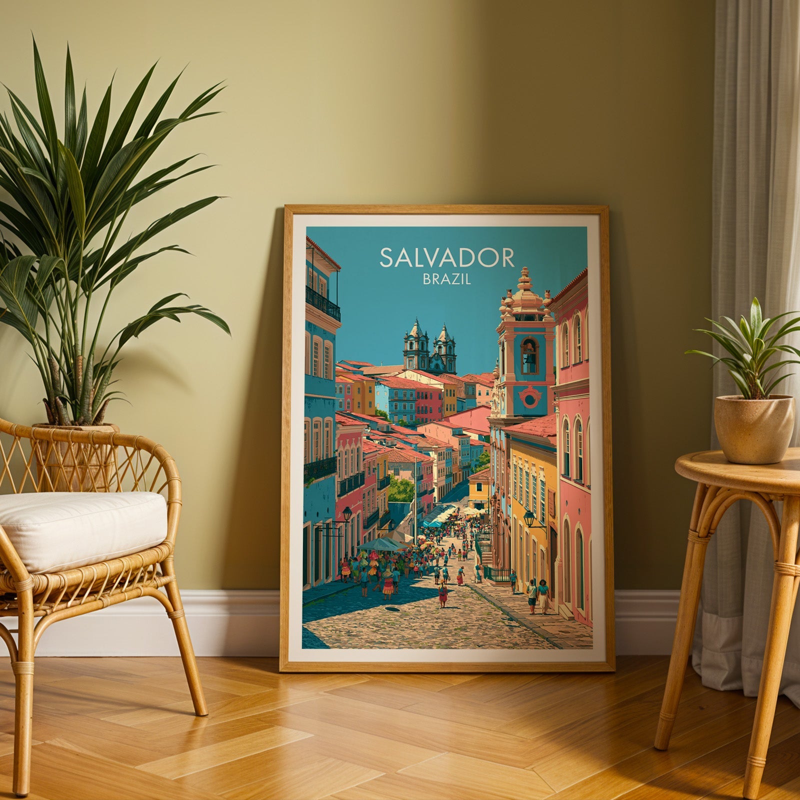 Salvador facades print in an oak frame on a herringbone floor by an olive wall, rattan chair and tall palm