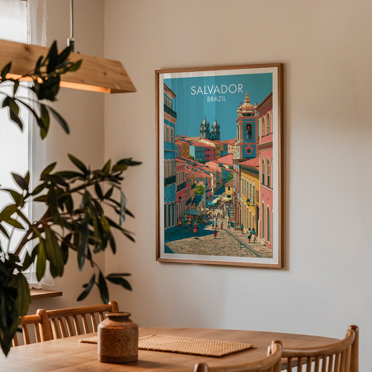 Pelourinho hill poster in an oak frame in a dining corner with a wood table, slat chairs and a pendant lamp