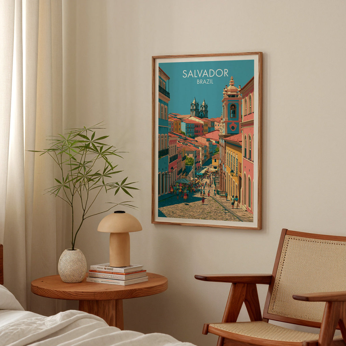 Colourful Salvador print in a walnut frame in a bedroom above a round nightstand with a terracotta mushroom lamp
