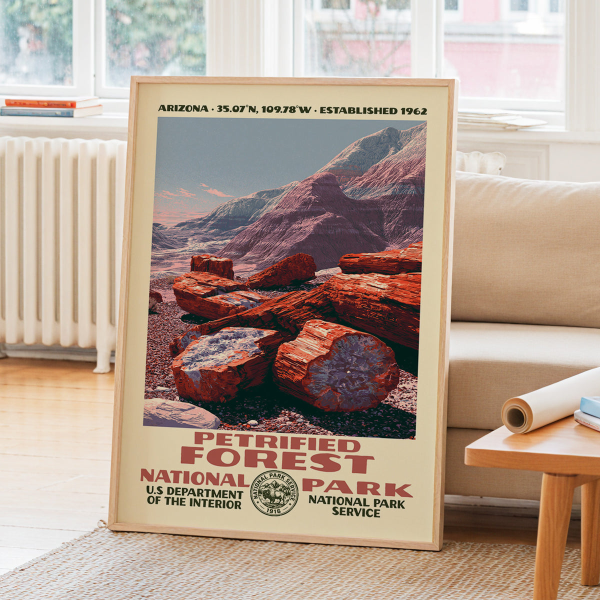 Petrified Forest National Park WPA travel poster leaning on a sunlit living room wall beside a linen sofa
