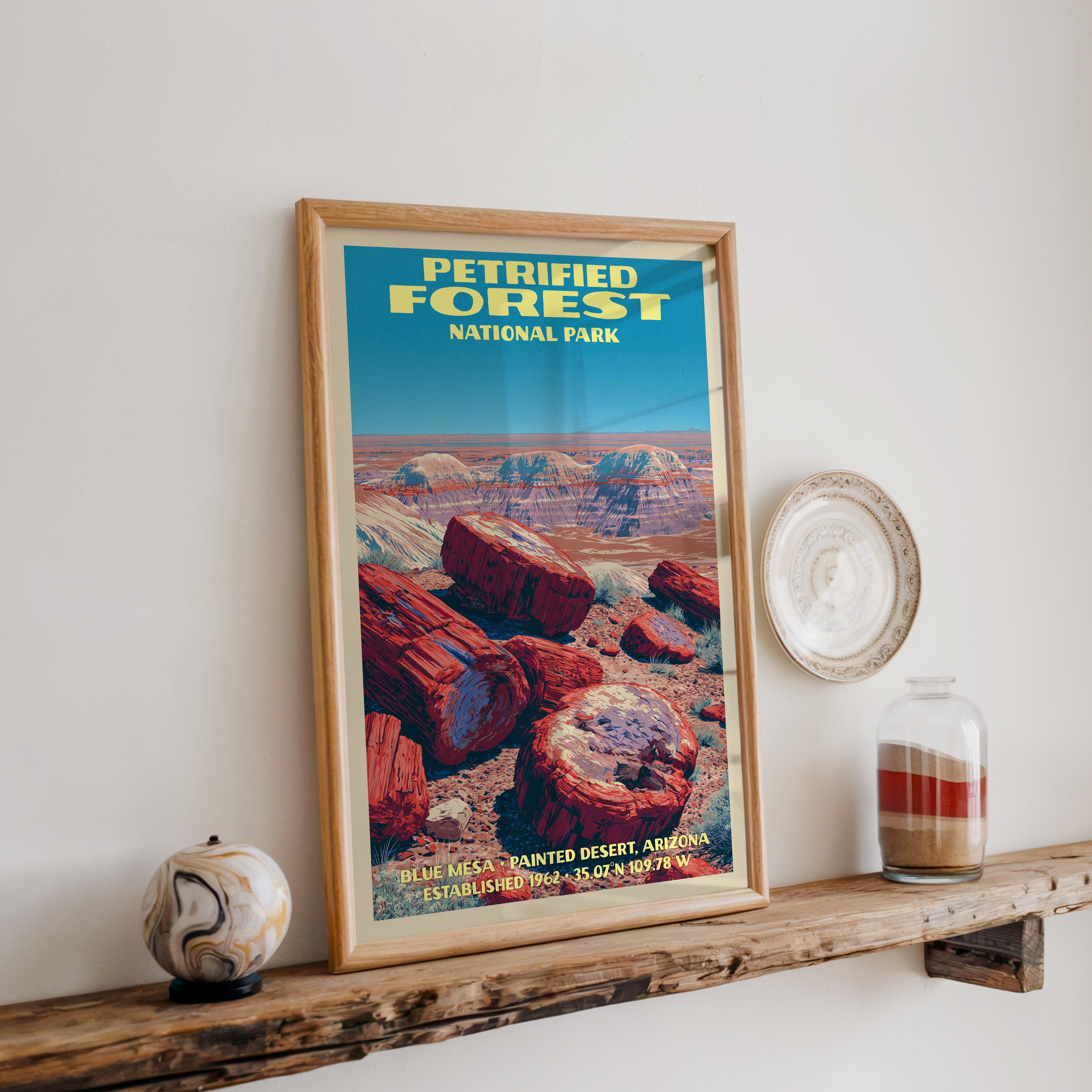 Petrified Forest Blue Mesa print in oak, leaning on a reclaimed wood ledge with a marbled sphere and sand jar