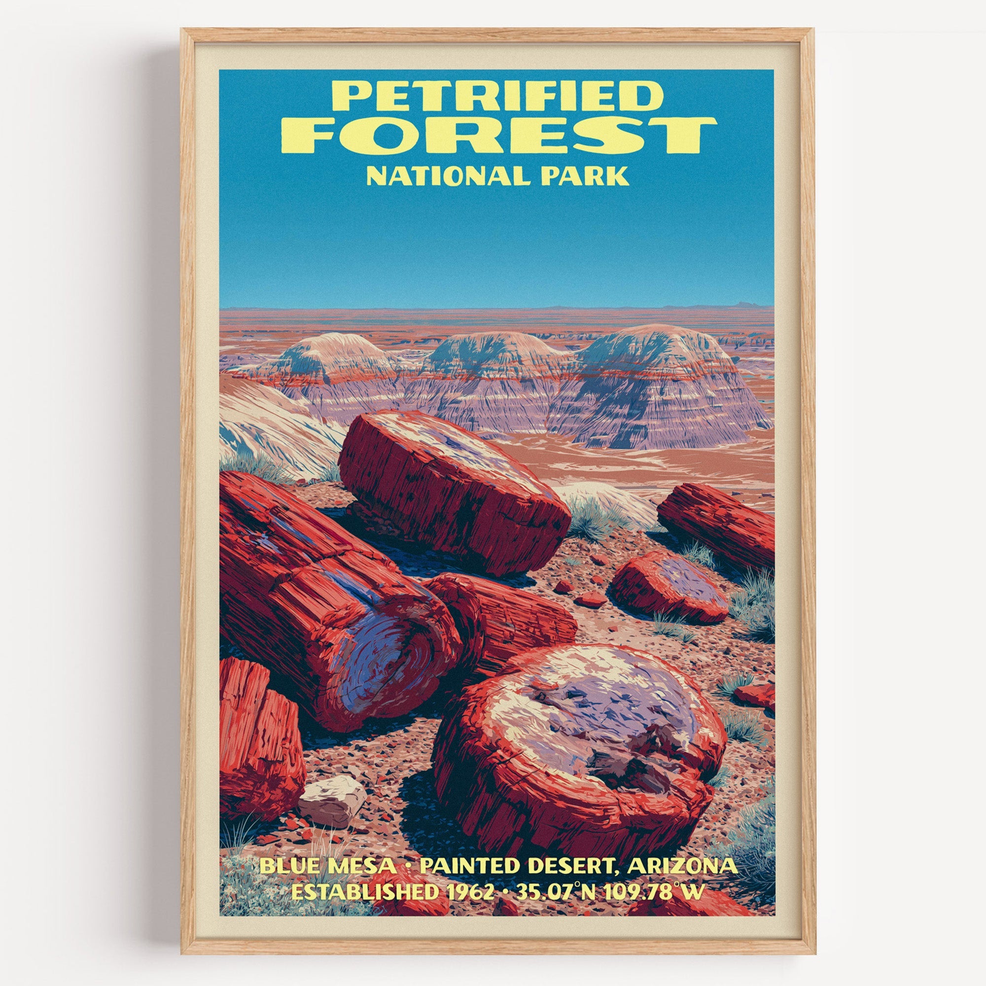 Blue Mesa Petrified Forest vintage poster in a light oak frame on a plain white wall