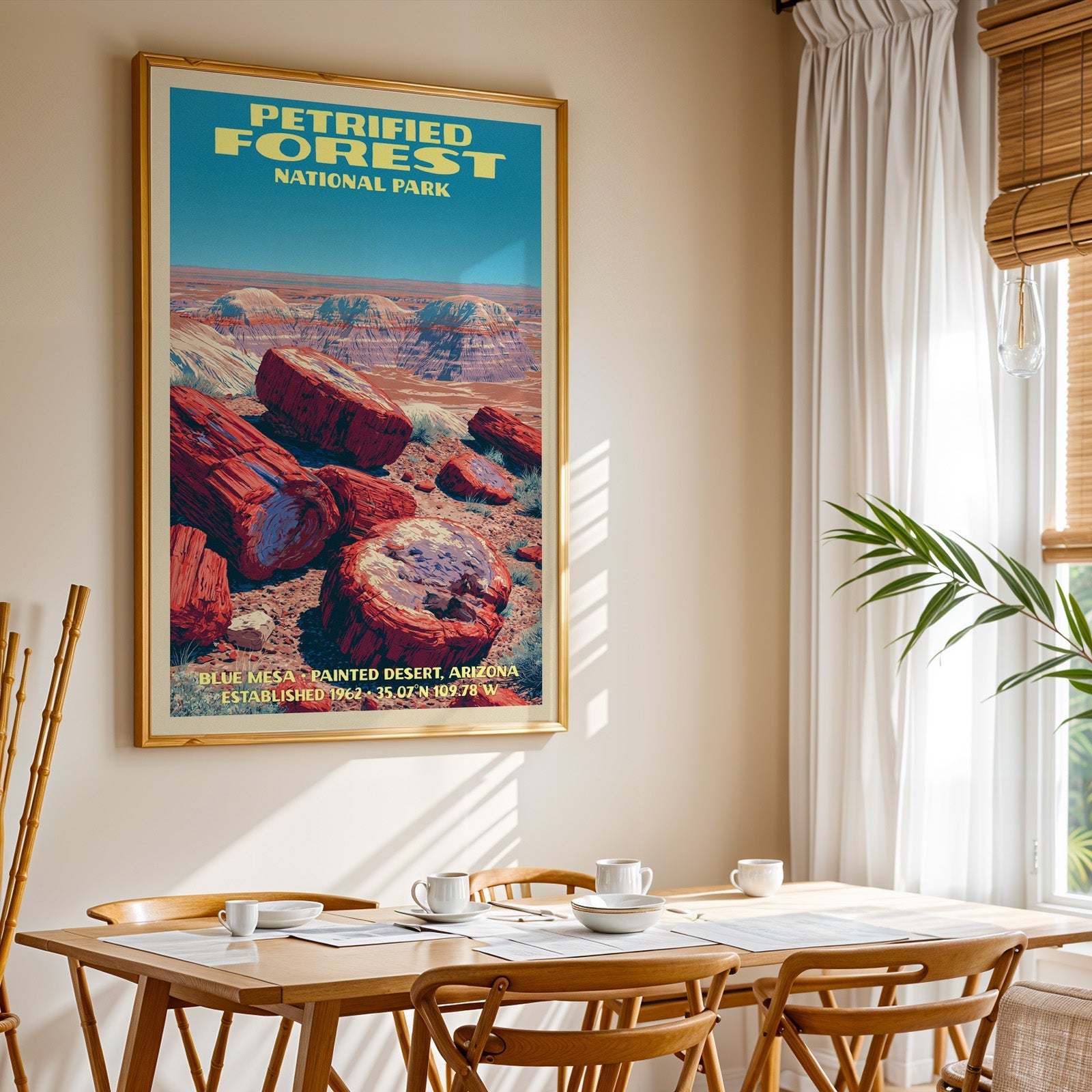 Petrified Forest National Park print in gold above a light oak dining table by a curtained window