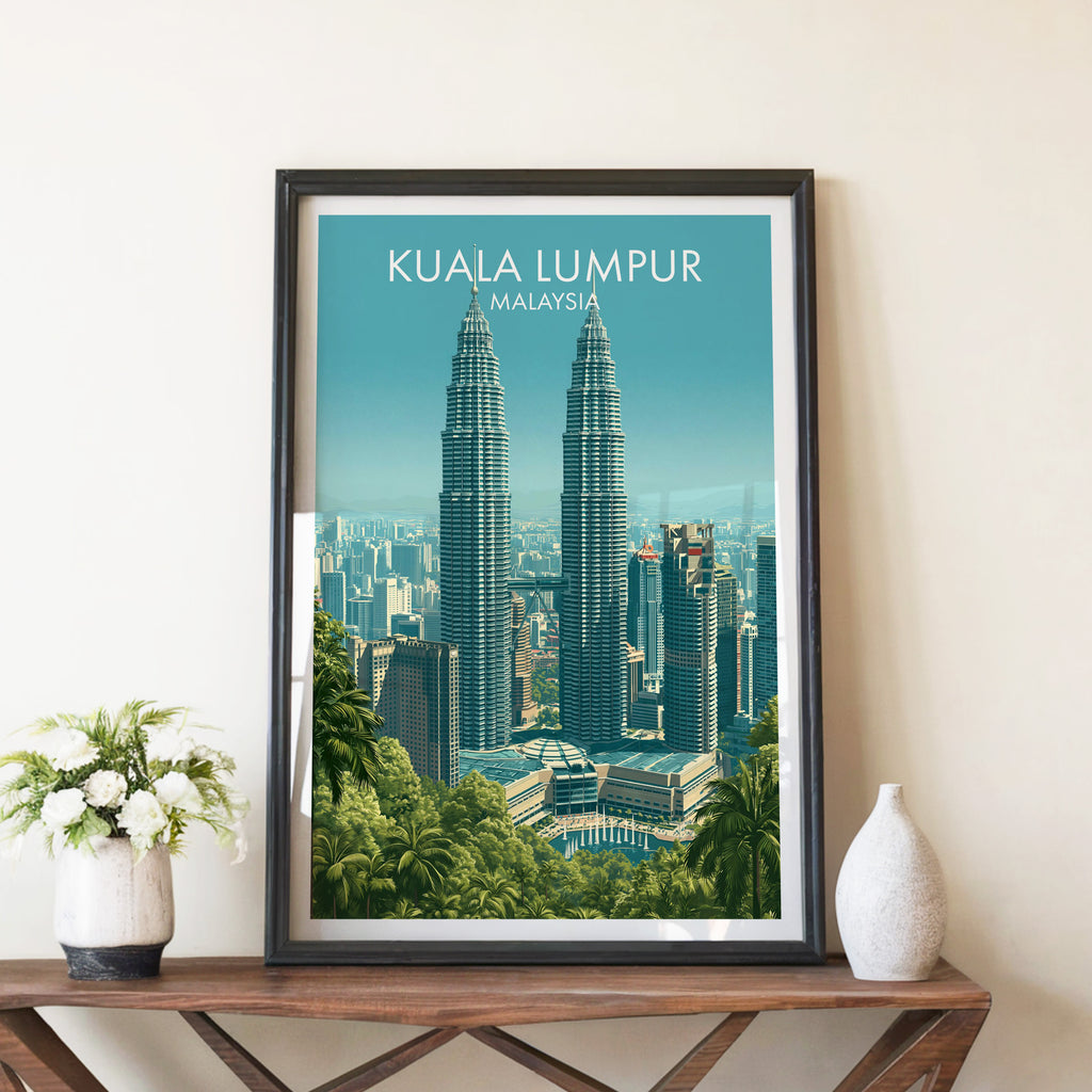 Petronas Towers Kuala Lumpur travel poster in a black frame on a wooden console table with white flowers