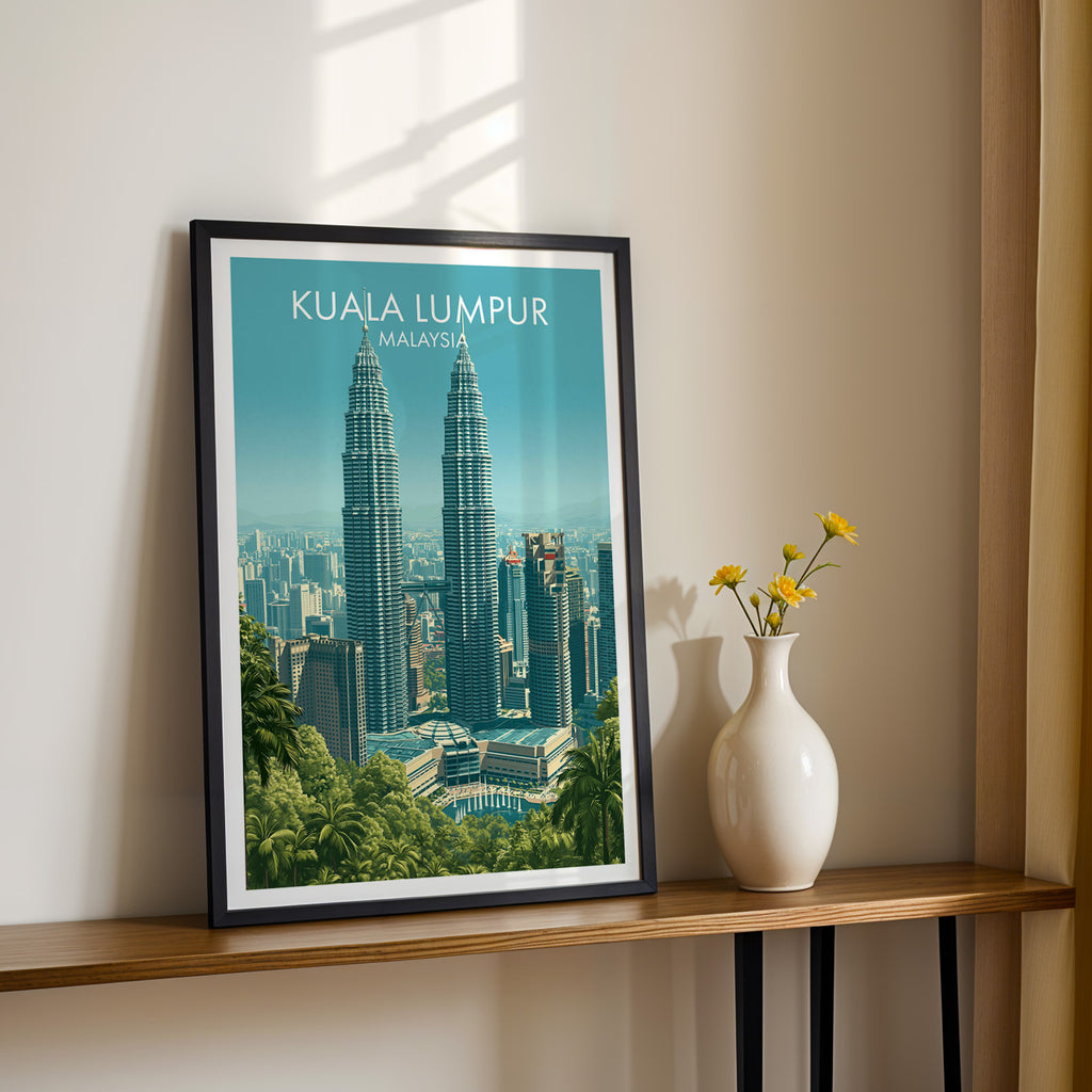 Black framed Petronas Towers Kuala Lumpur print on a narrow hallway console in sunlight, styled with yellow flowers