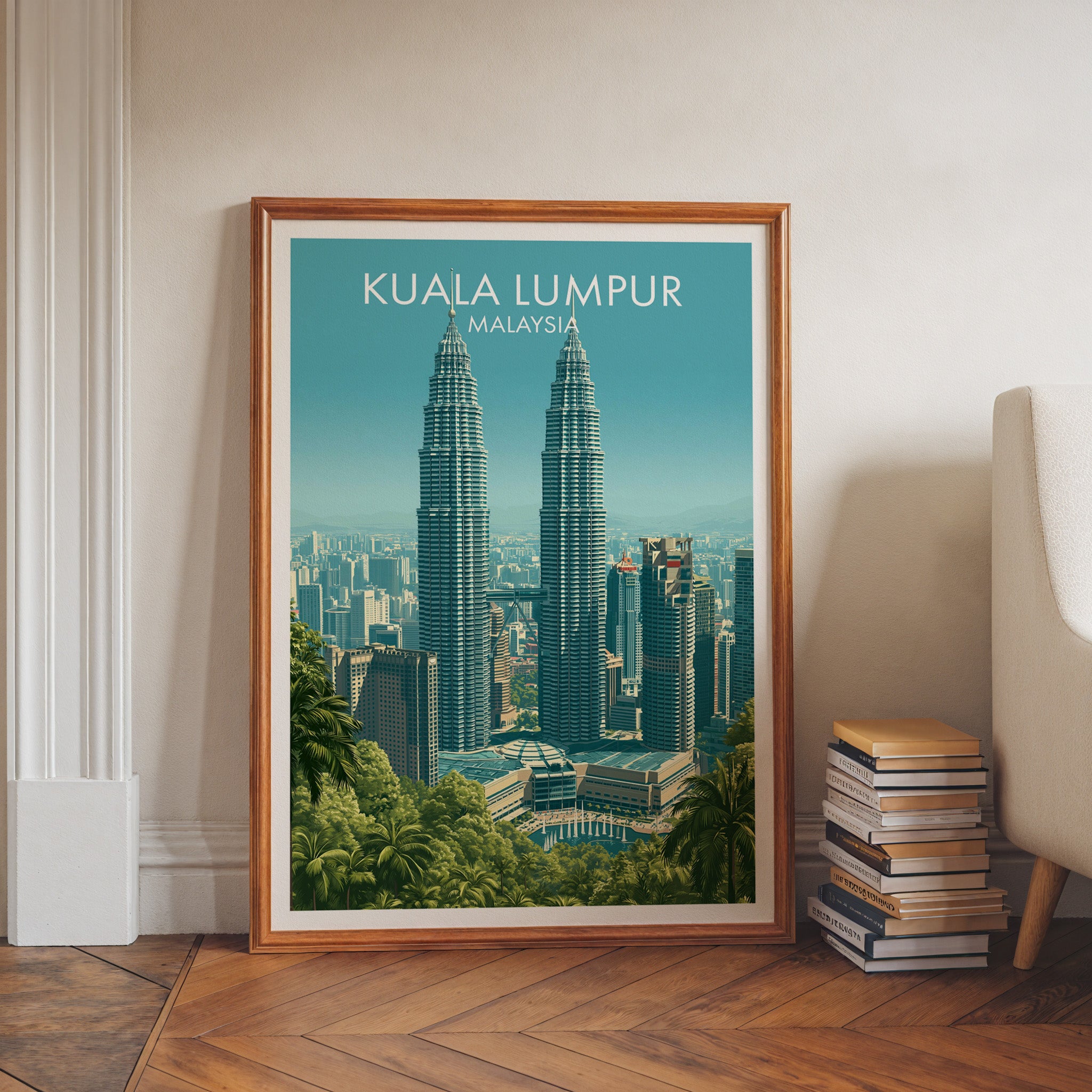 Petronas Towers Kuala Lumpur art print in a walnut frame leaning in a hallway beside stacked books