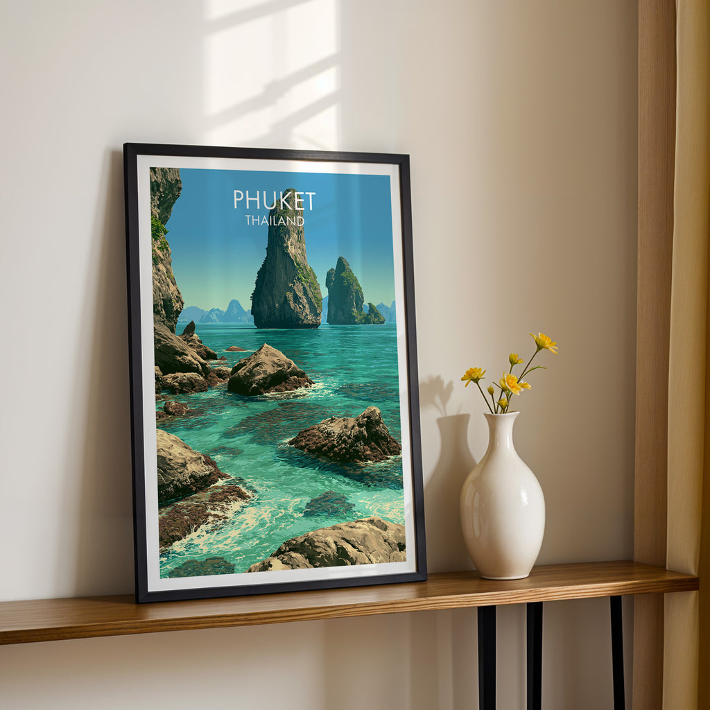 Black framed Phang Nga Bay Phuket Thailand print on a narrow hallway console in sunlight, styled with yellow flowers