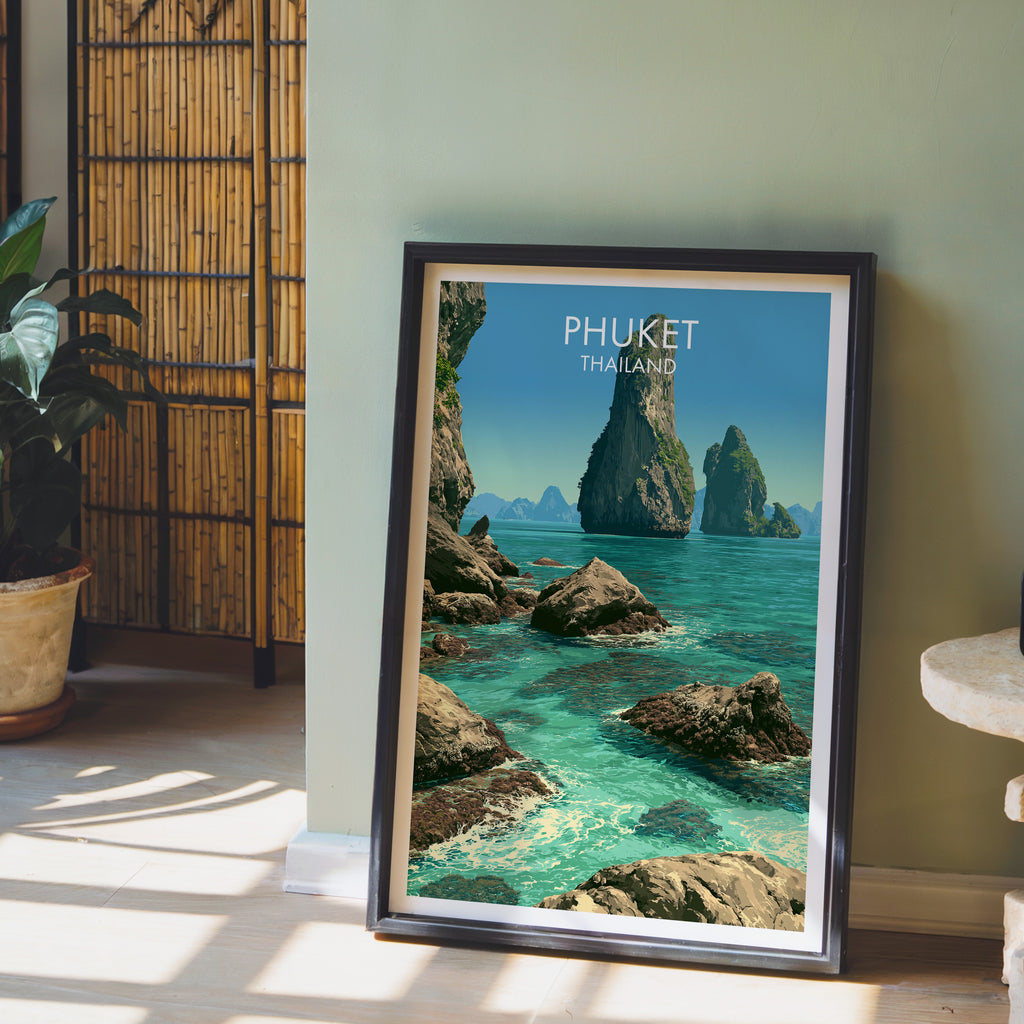 Phang Nga Bay Phuket Thailand wall art in a black frame leaning against a sage green wall beside a bamboo screen