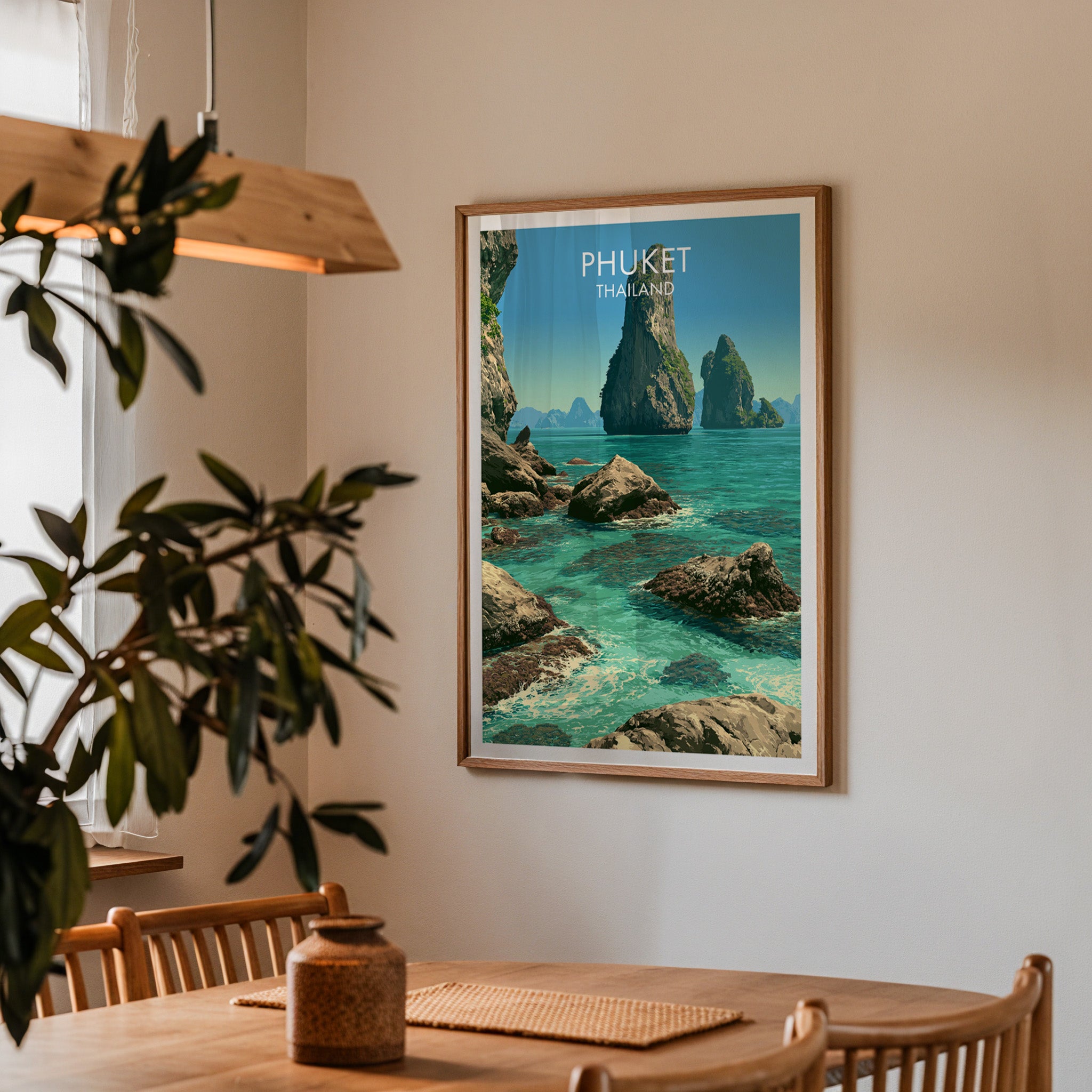 Framed Phang Nga Bay Phuket Thailand print on a dining room wall above an oak table in warm afternoon light