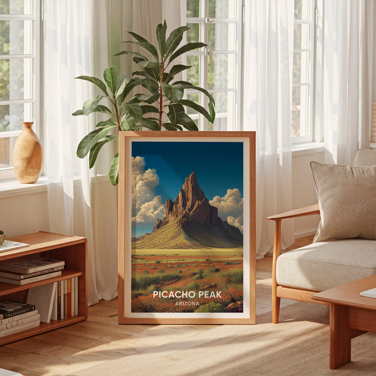 Arizona desert poster leaning at a curtained window with a low bookshelf and coffee table