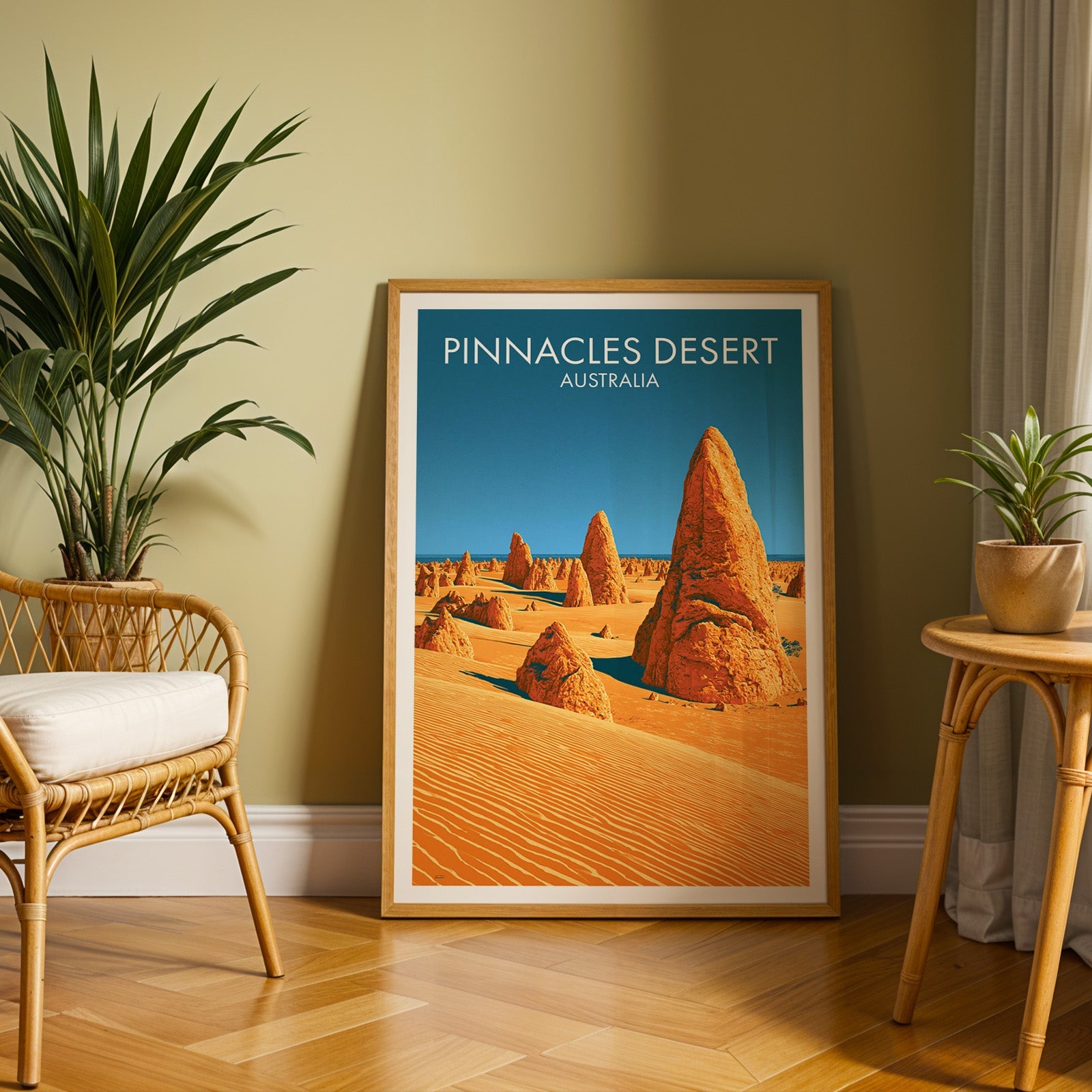 Western Australia desert poster in an oak frame on herringbone parquet with an olive wall and rattan chair