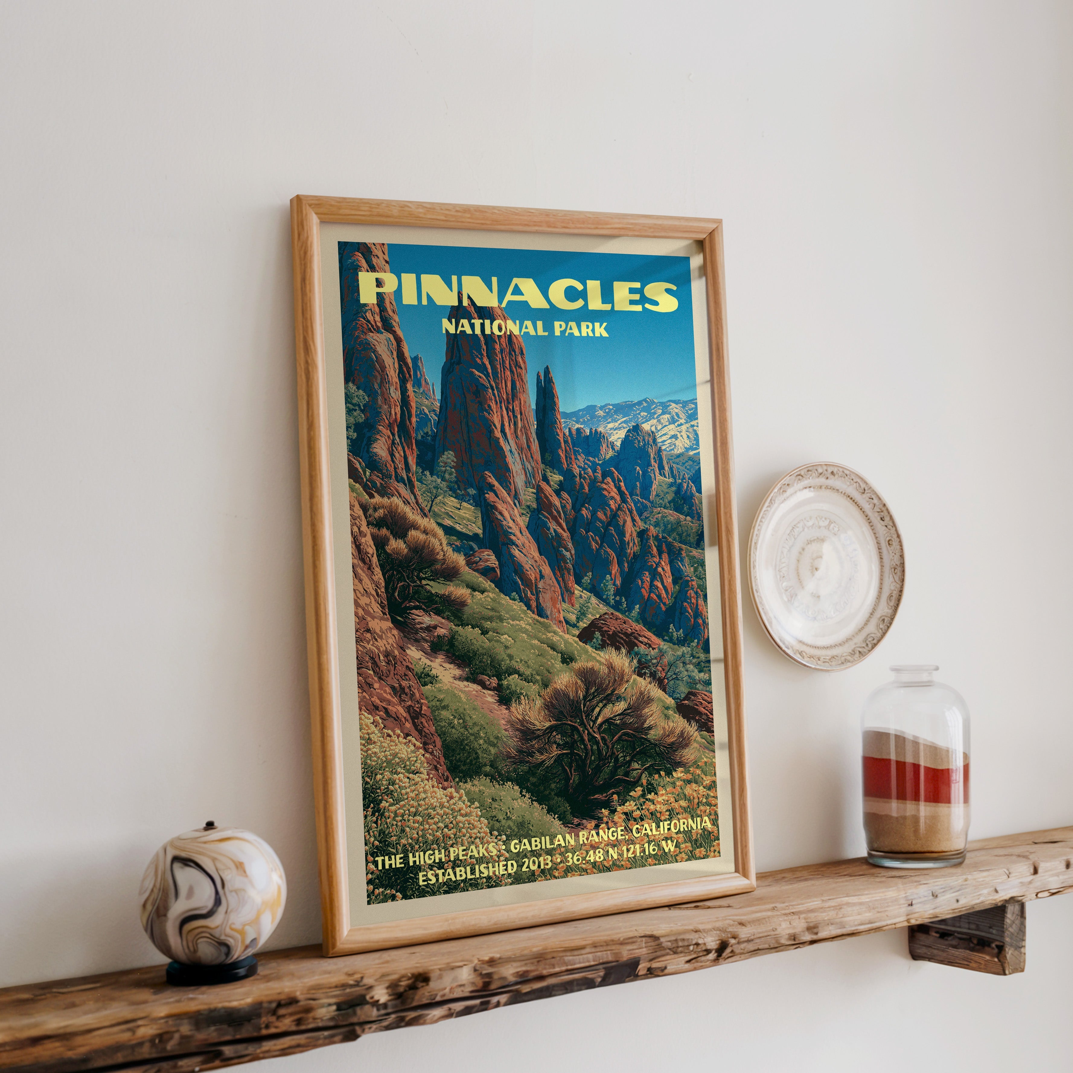 Pinnacles High Peaks print in oak, leaning on a reclaimed wood ledge with a marbled sphere and a sand jar