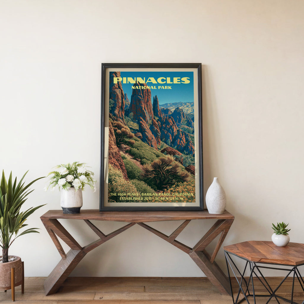 Pinnacles High Peaks wall art in black, leaning on a walnut console with white anemones and a vase