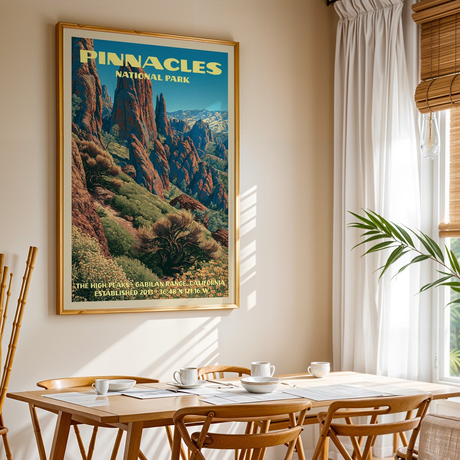 Pinnacles National Park rock spire print in gold above a light oak dining table by a curtained window