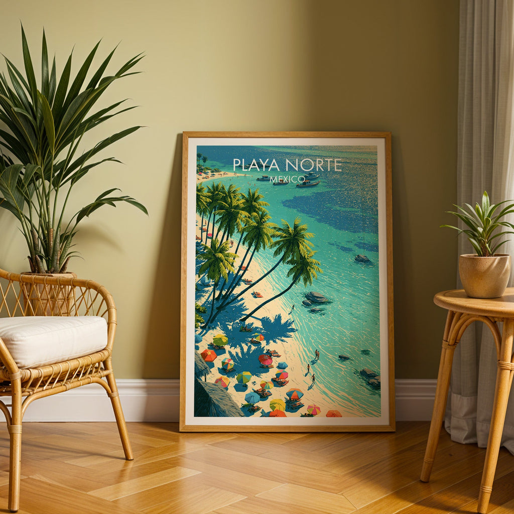 Isla Mujeres beach poster in an oak frame on herringbone parquet, olive wall, rattan chair and plant.