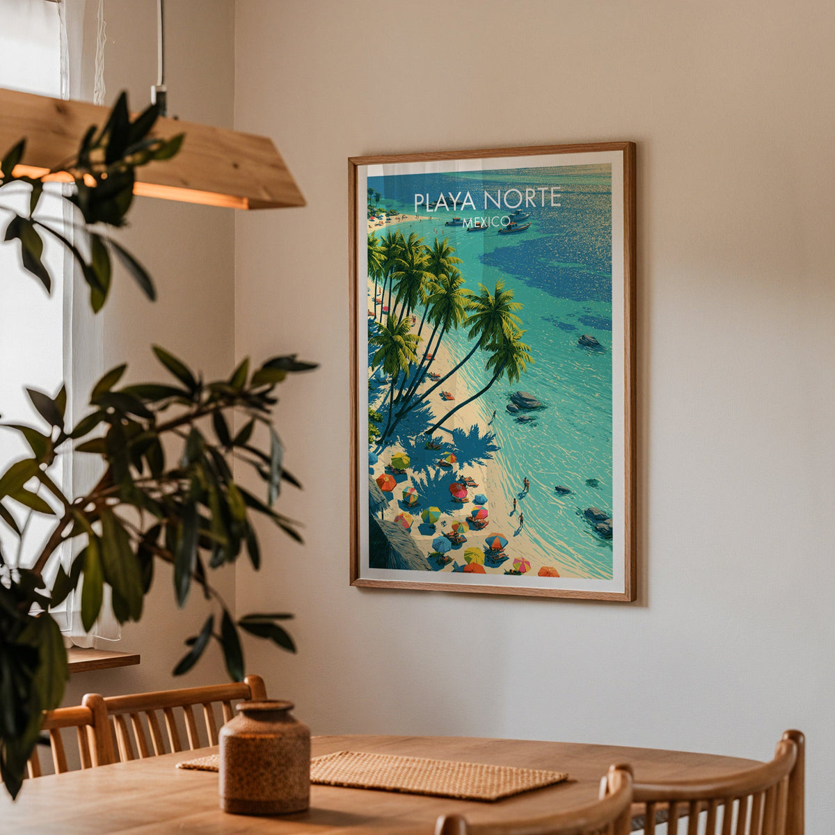 Playa Norte travel art in an oak frame in a dining corner with spindle chairs and a wood pendant lamp.
