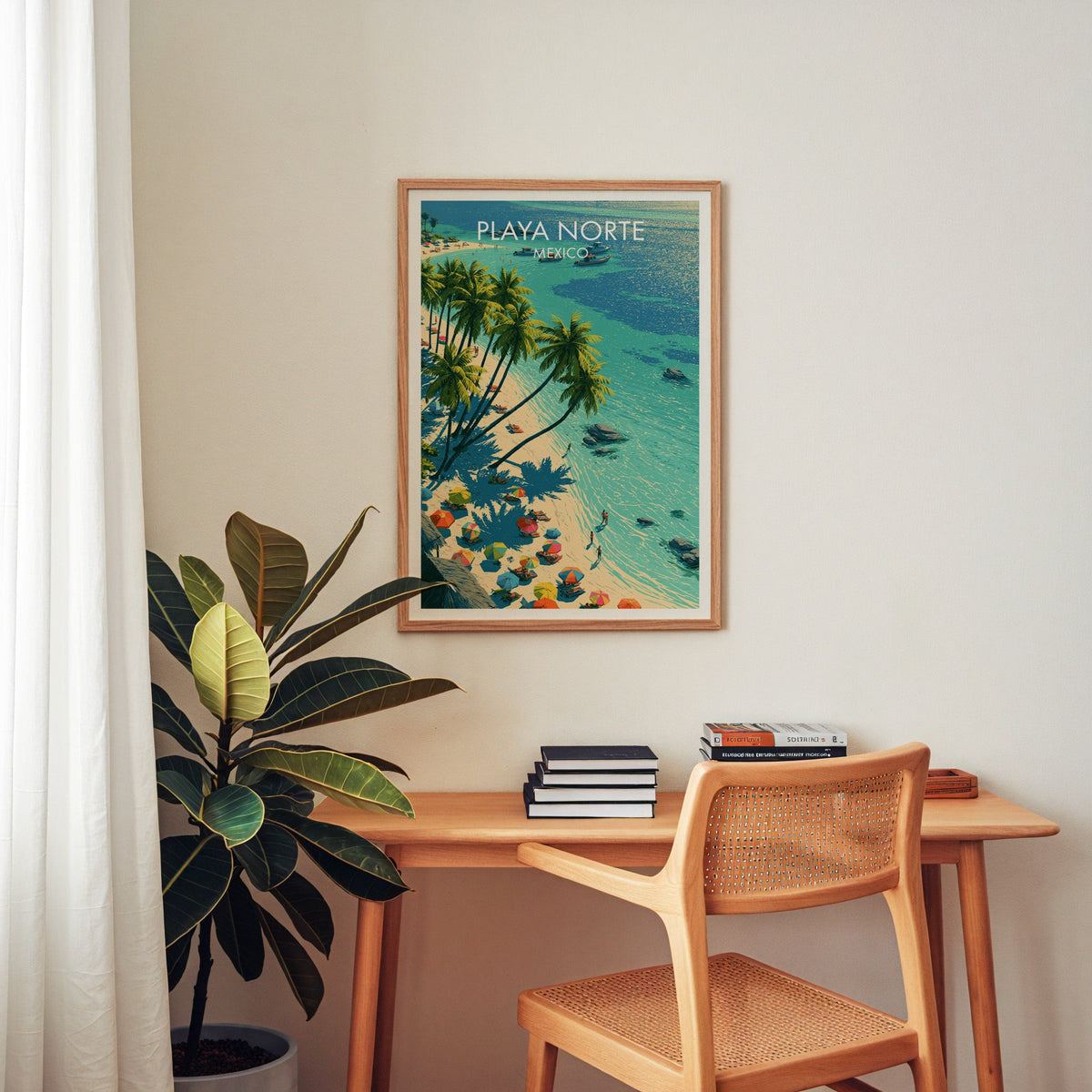 Palm-fringed shoreline poster in an oak frame above a wooden home-office desk with a cane chair.