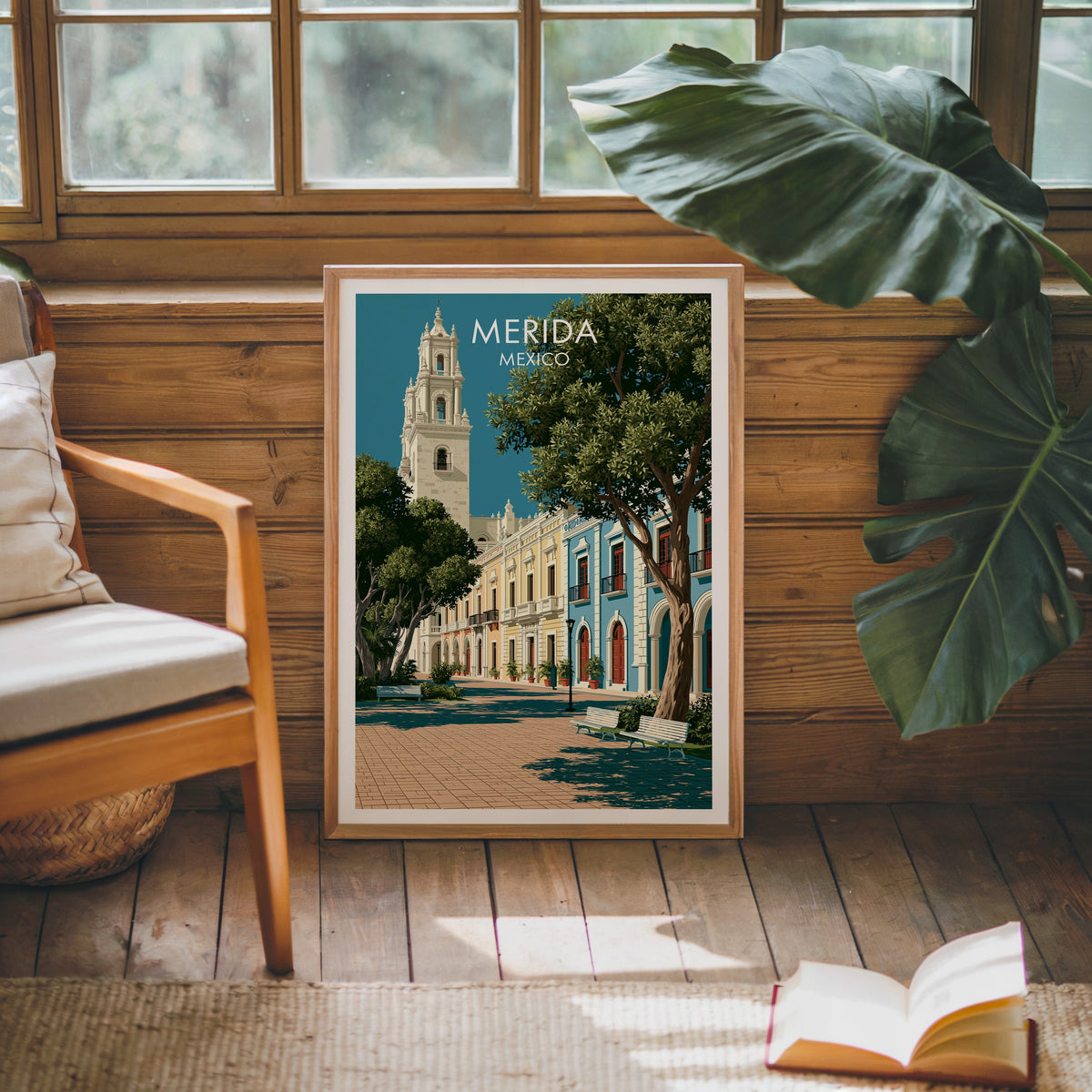 Merida town square art in an oak frame on a pine cabin wall with a wooden armchair and jute rug.