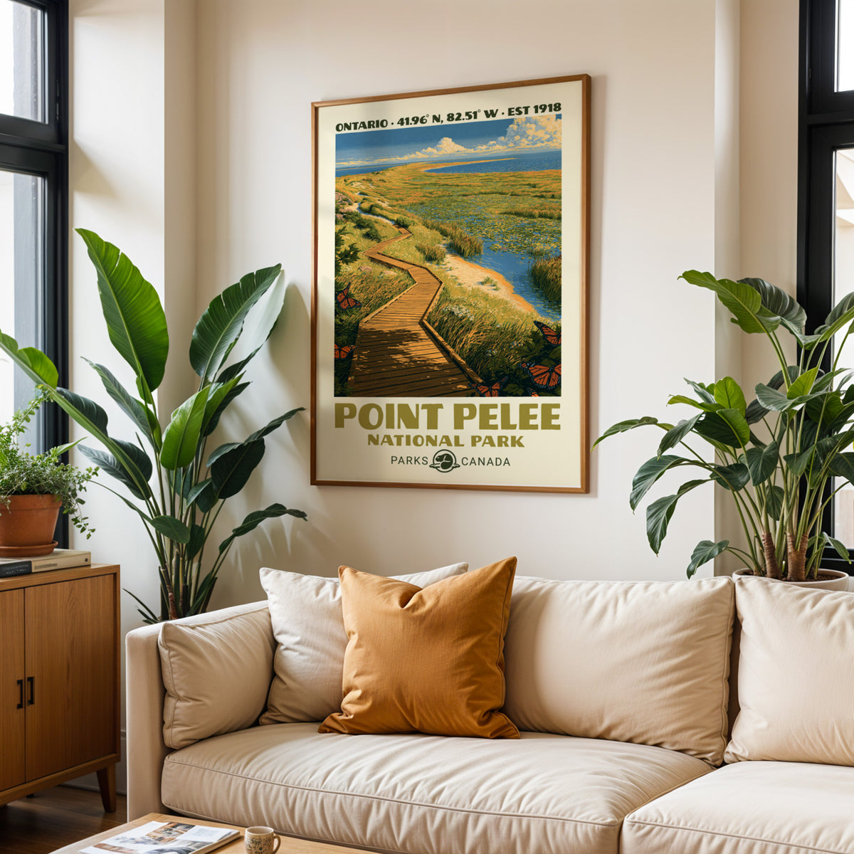 Point Pelee National Park print in an oak frame above a cream sofa with a rust cushion
