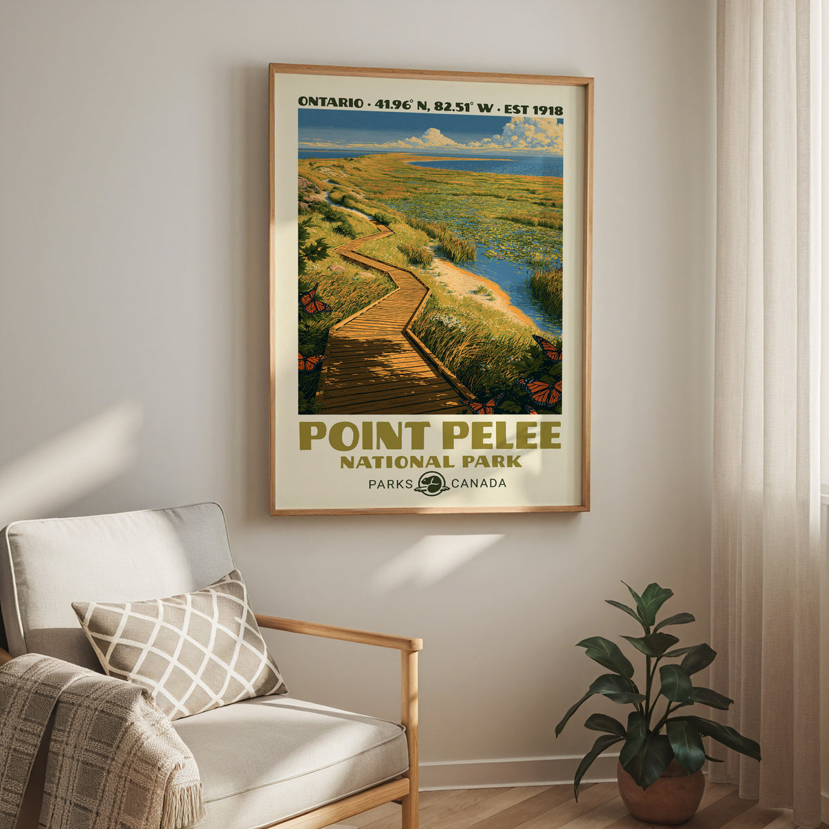 Point Pelee National Park print in an oak frame above a cream armchair and a rubber plant