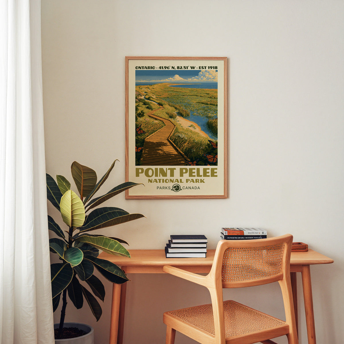 Point Pelee Canada vintage poster in an oak frame above a wood desk with a cane chair