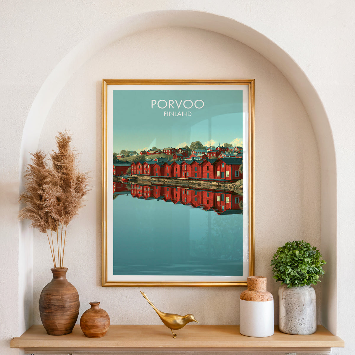Porvoo river reflection poster, gold frame in an arched wall niche above pampas grass in a clay vase