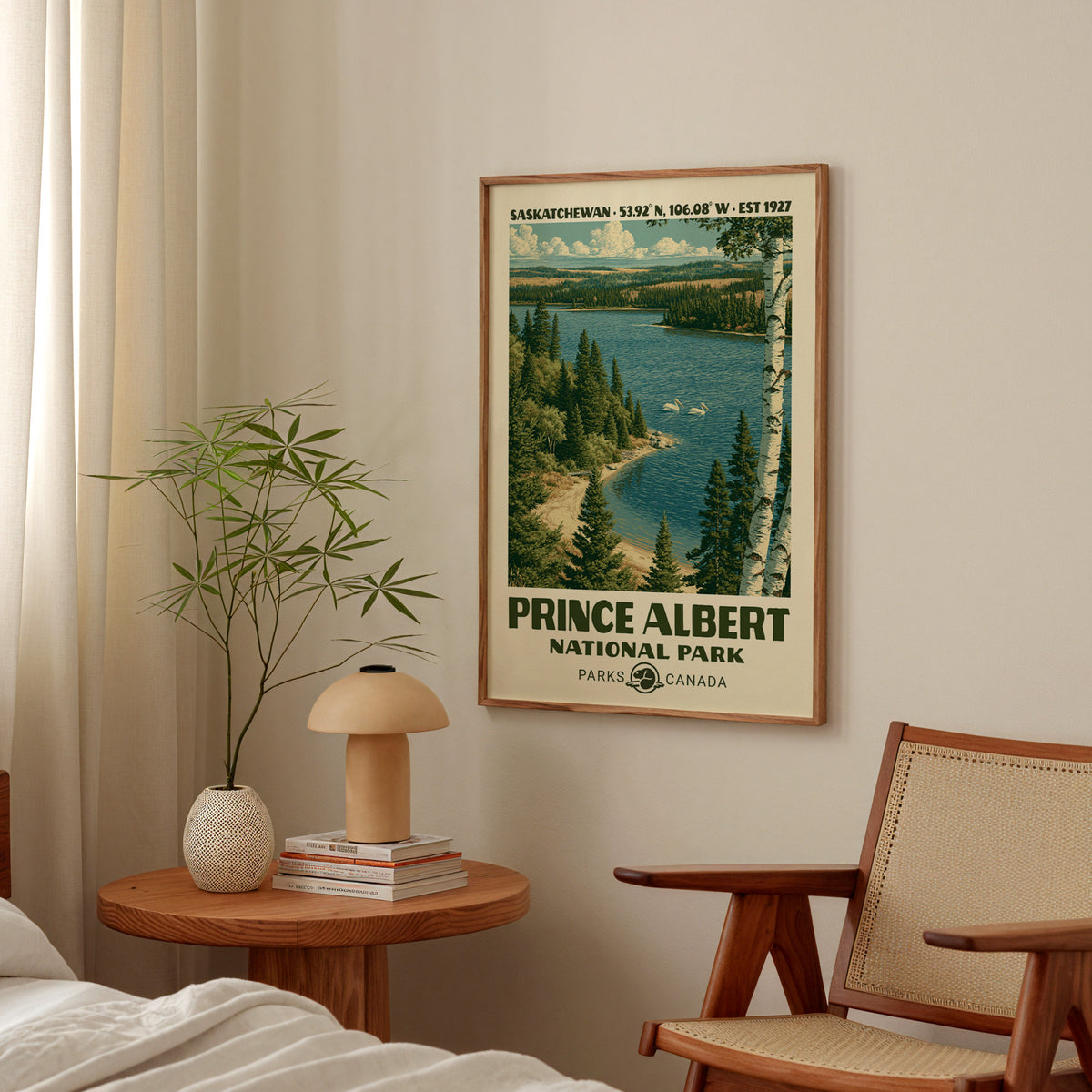Prince Albert boreal lake poster in an oak frame above a bedside table with a mushroom lamp