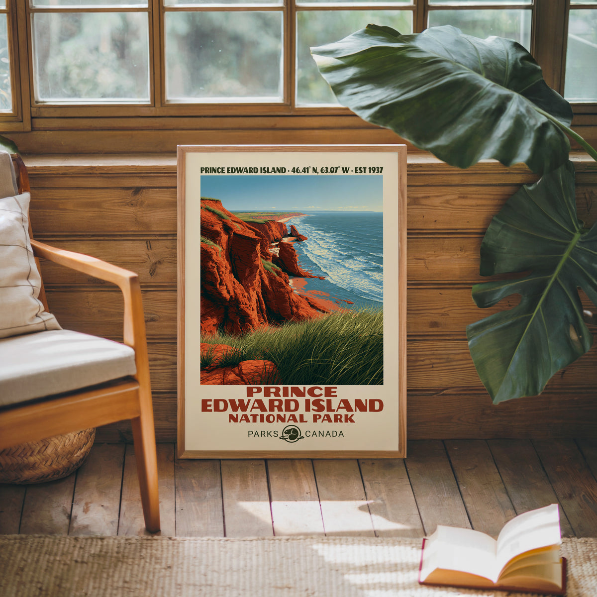 Prince Edward Island Canada poster in an oak frame against a pine cabin wall beside a monstera