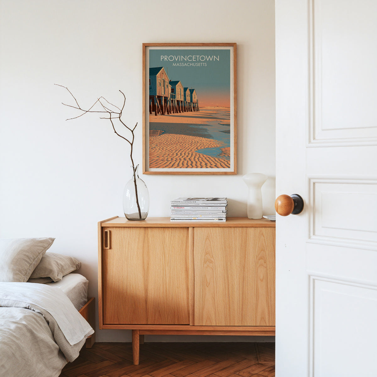 Provincetown Massachusetts wall print in an oak frame on a sideboard with dried stems in glass