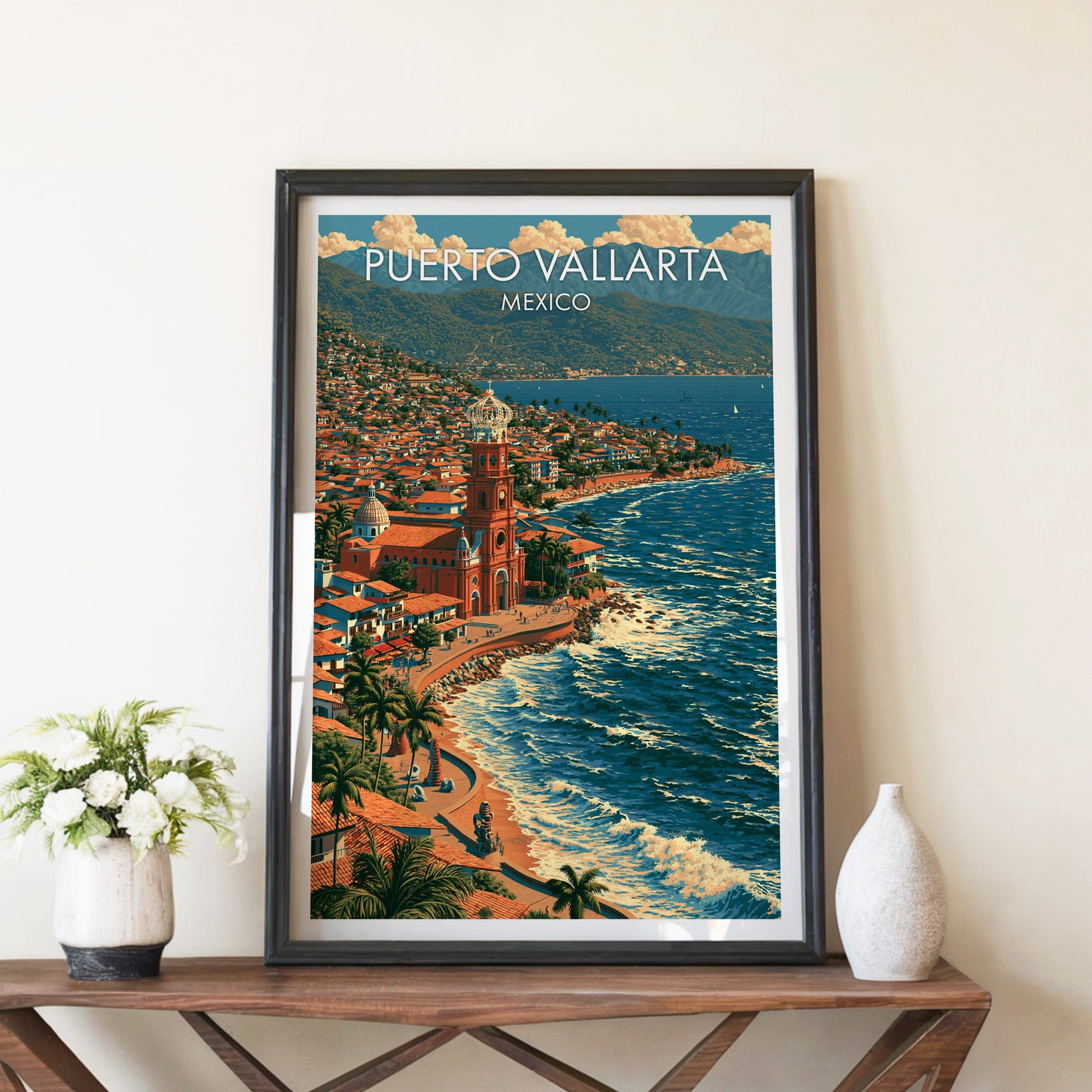 Bay and surf artwork in a black frame on a walnut console with white peonies and a ceramic vase
