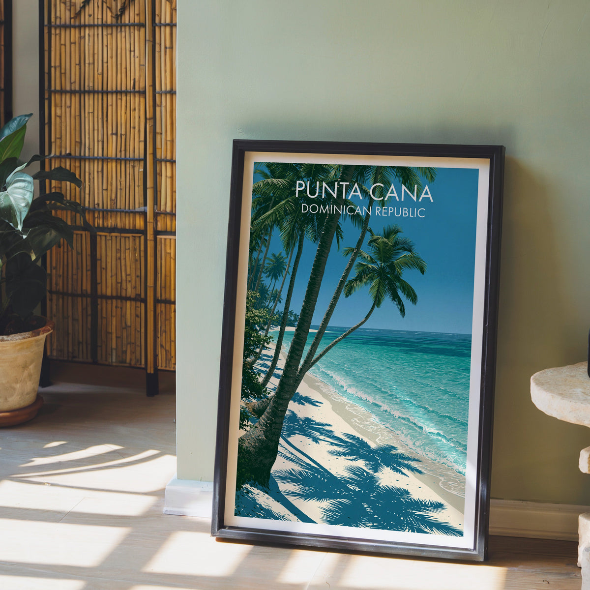 Turquoise shallows and breaking surf, black frame leaning on pale wood floor by a sage wall and bamboo screen
