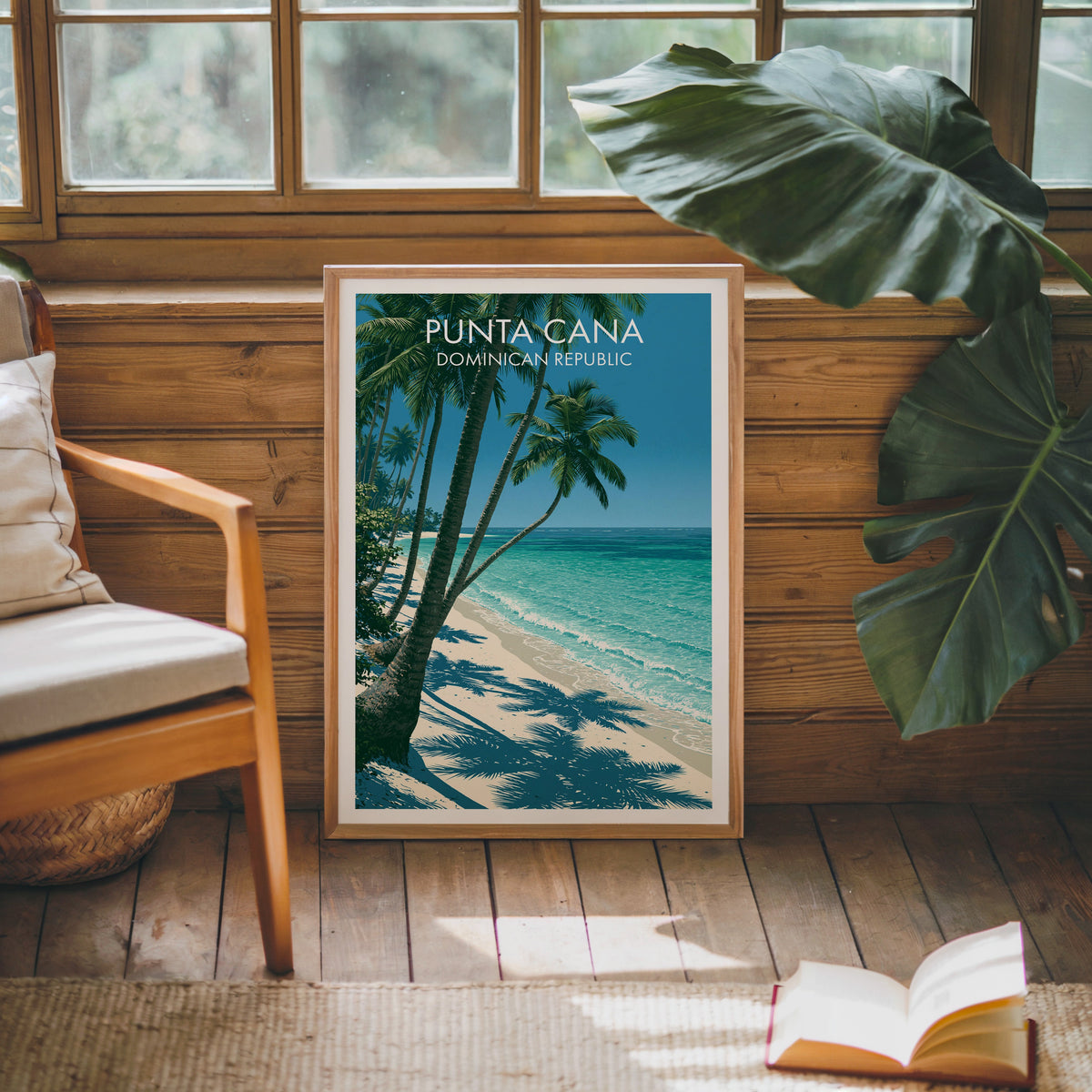 White sand and blue sea in an oak frame on a pine cabin wall with a wooden armchair and monstera leaf