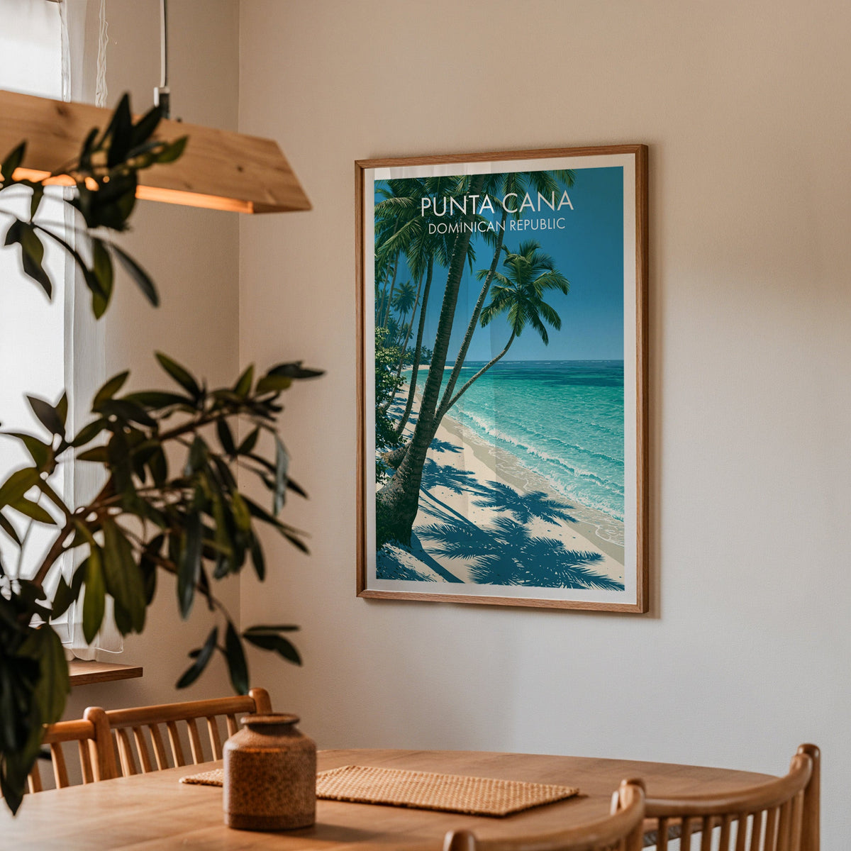 Punta Cana shoreline in an oak frame over an oak dining table with spindle chairs and a wood pendant lamp
