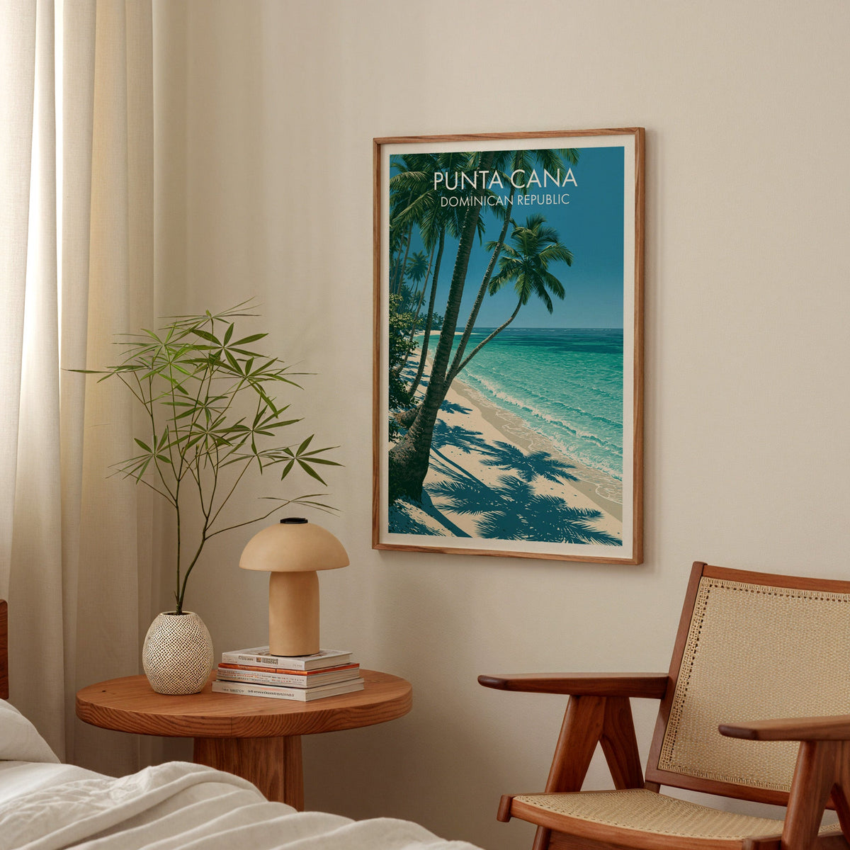 Dominican Republic travel art in an oak frame above a bedside table with a mushroom lamp and bamboo stems
