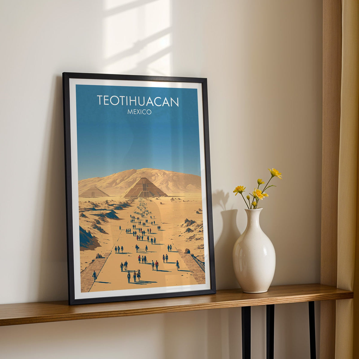 Golden avenue of walkers, black frame on a wood shelf with yellow daisies against a sunlit cream wall