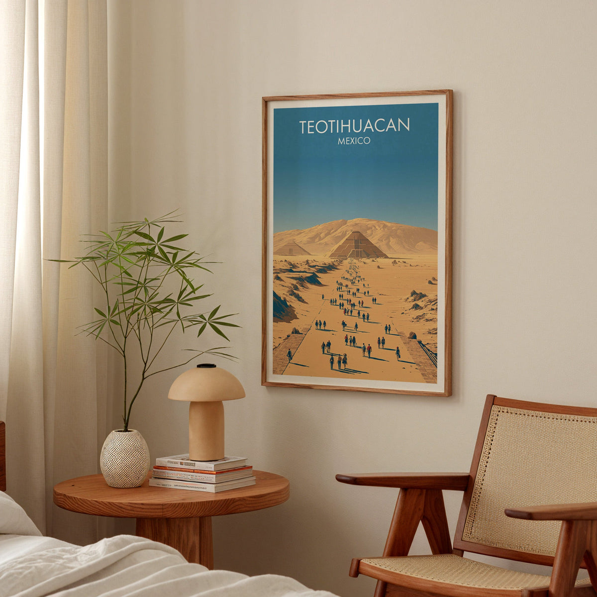 Teotihuacan avenue print in an oak frame in a bedroom above a round bedside table and mushroom lamp
