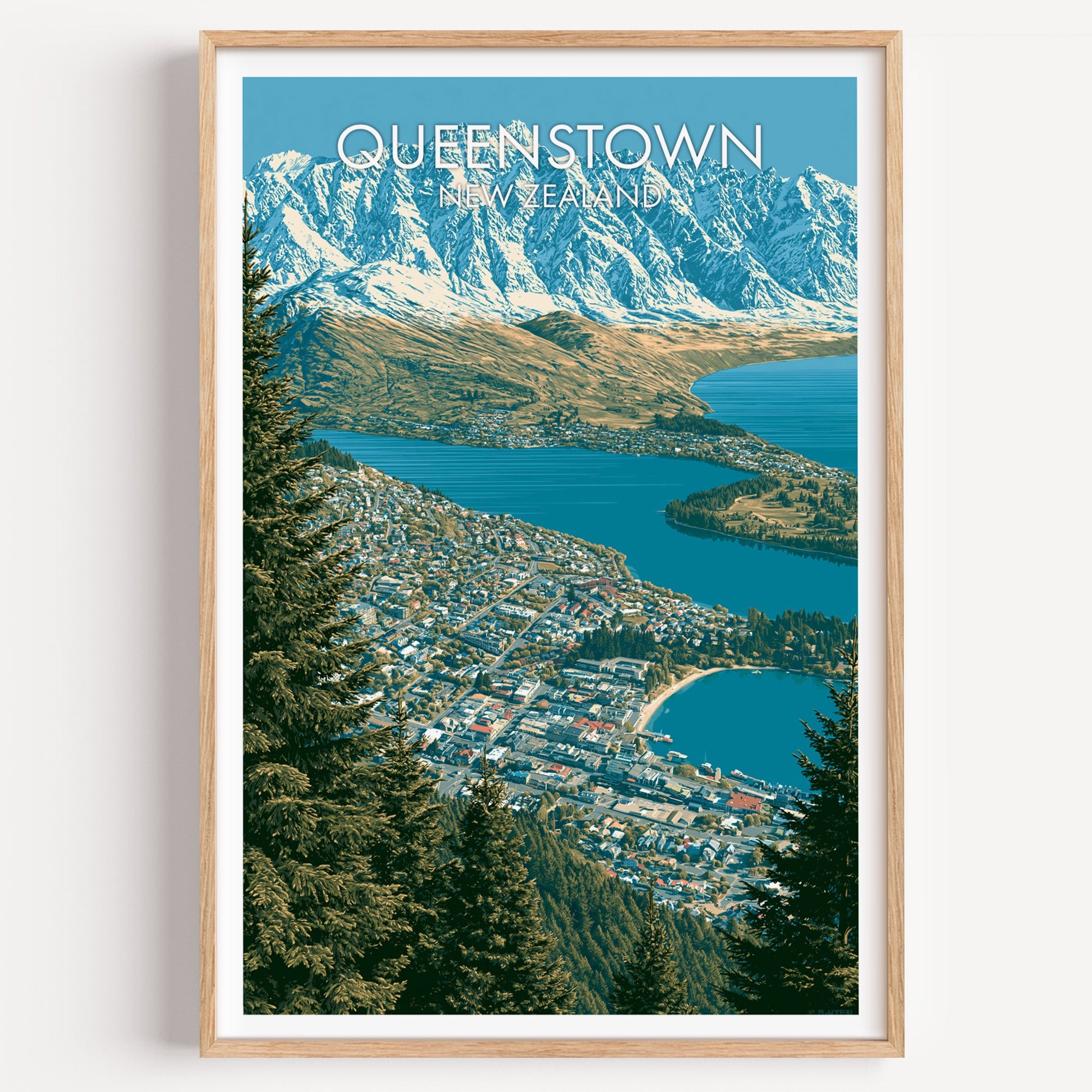 Queenstown travel print in a light oak frame on a plain white wall