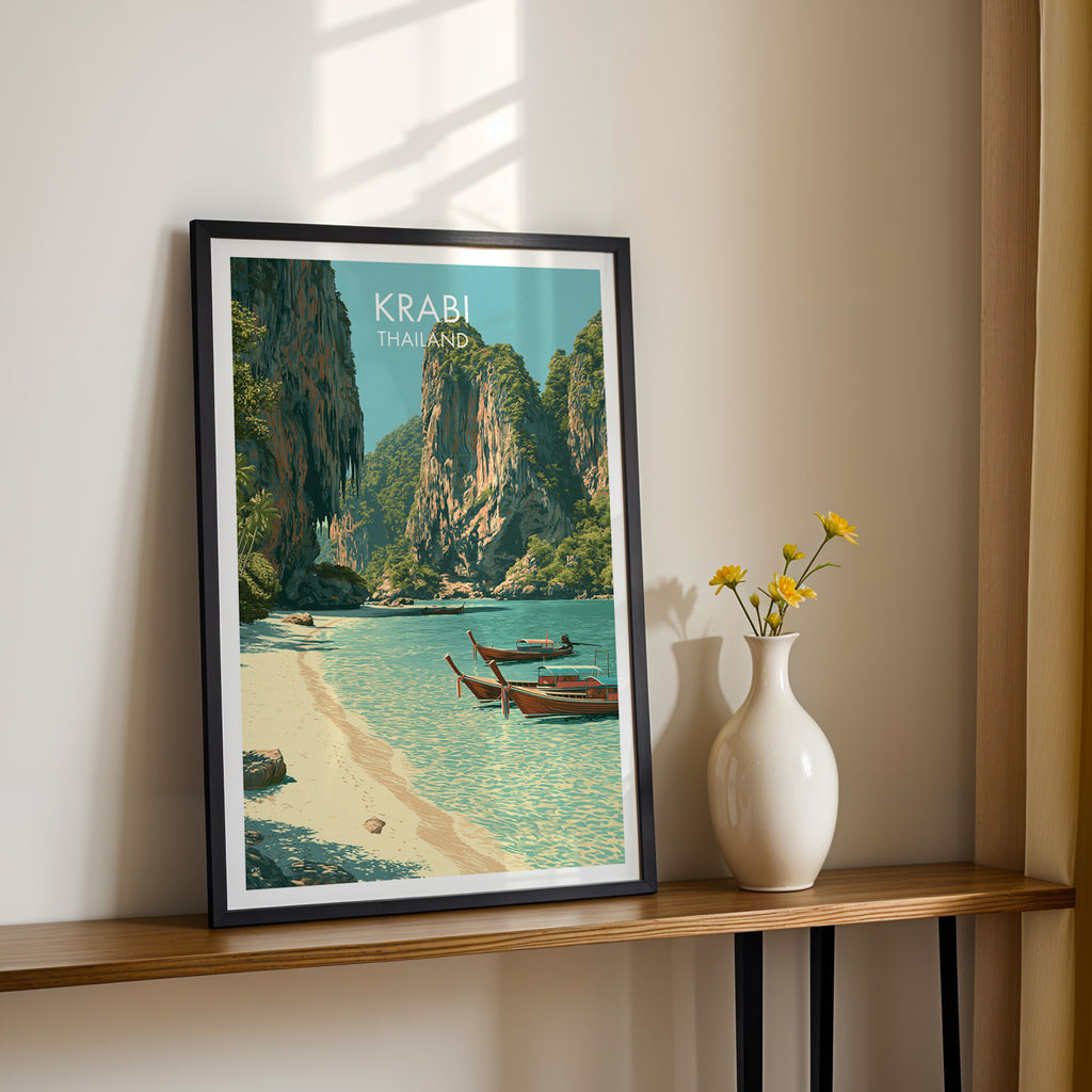 Black framed Railay Beach Krabi Thailand print on a narrow hallway console in sunlight, styled with yellow flowers