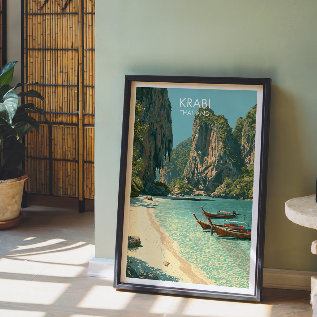 Railay Beach Krabi Thailand wall art in a black frame leaning against a sage green wall beside a bamboo screen