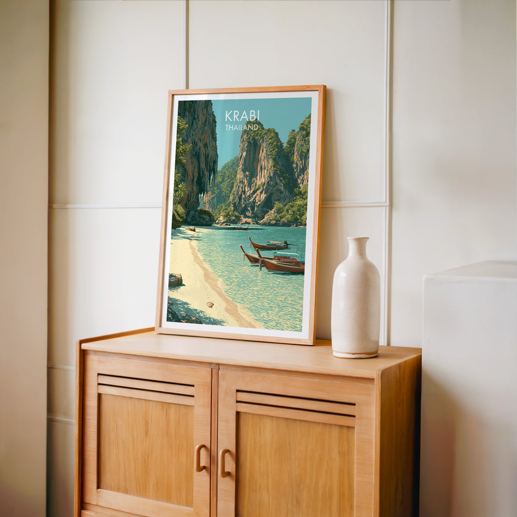Small Railay Beach Krabi Thailand travel poster in an oak frame on a mid-century sideboard with a ceramic vase