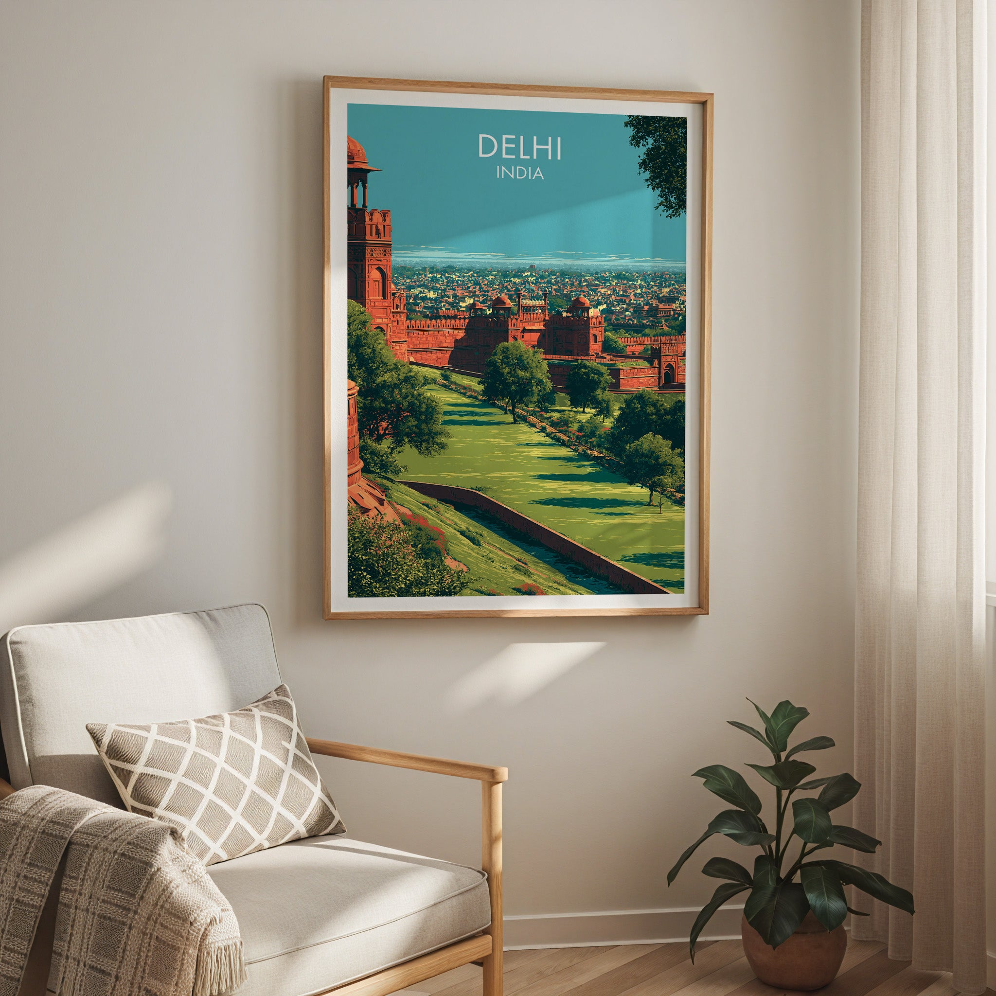 Red Fort Delhi India travel print in a light oak frame on a living room wall beside a linen armchair