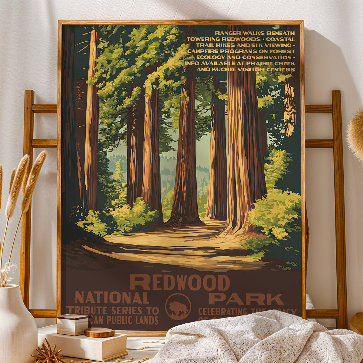 Redwood National Park vintage print on a wooden stand with folded blankets and books