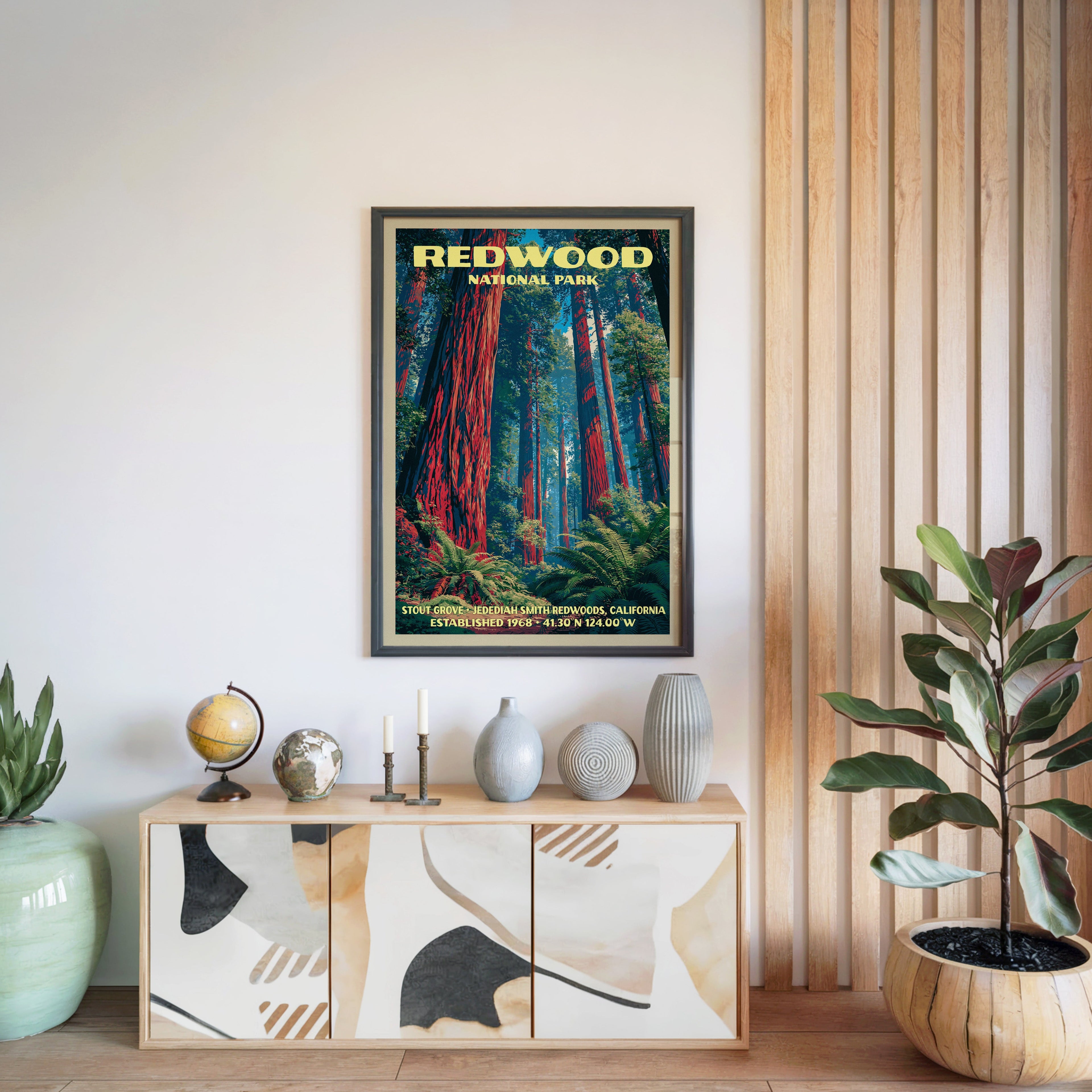 Redwood National Park print in a black frame above a light wood sideboard by a slatted wall panel