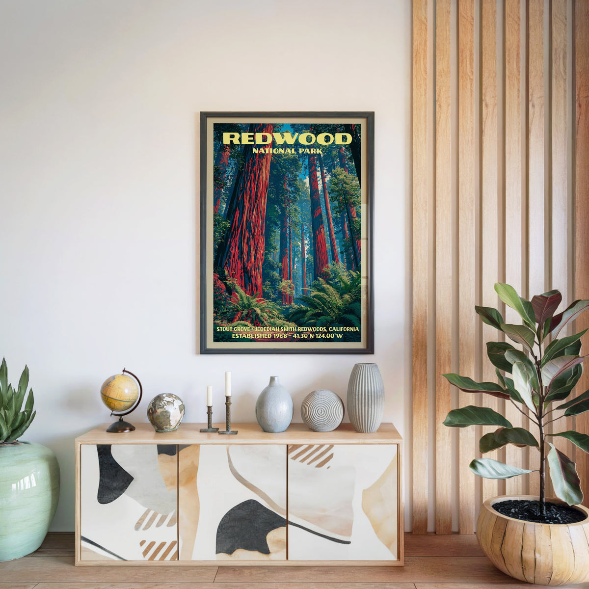 Redwood National Park print in a black frame above a light wood sideboard by a slatted wall panel