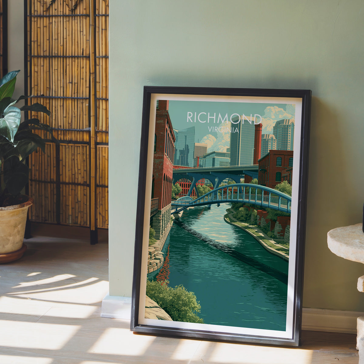 Richmond wall art in a black frame on a sage green wall beside a bamboo screen in slanted light.